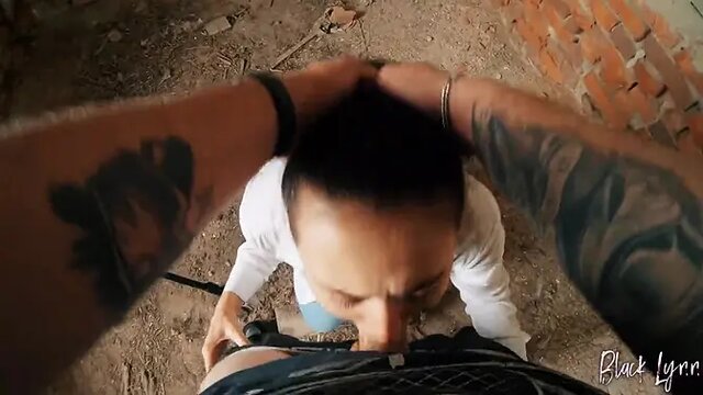 Black Lynn deepthroats cock in a dirty abandoned building