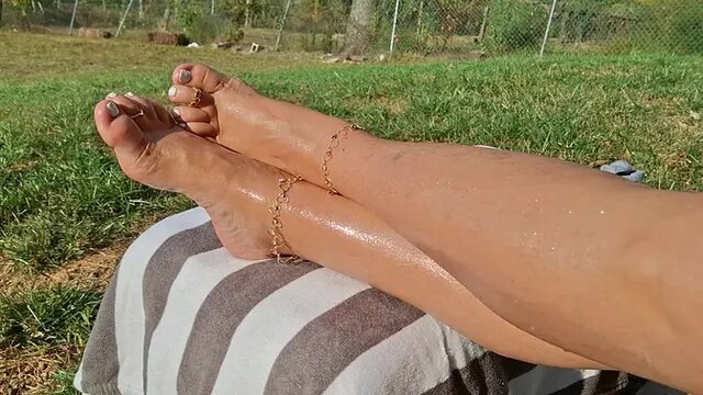 Tanned Beauty Shows Off Her Sexy Feet Up In The Air