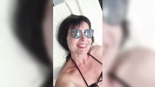 Sultry Julie oiled down, exposing her tantalizing curves on a secluded beach