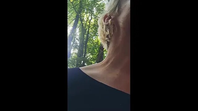 Mature MILF sucks and jacks off giant cock in public woods