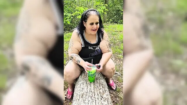 Woodland MILF sucks on a straw and squirts on a tree