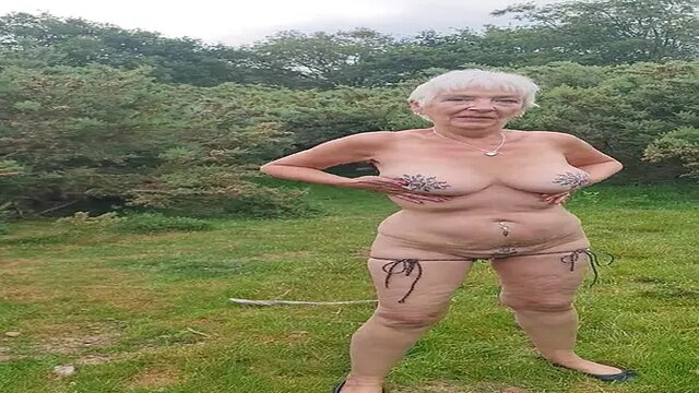 Outdoor nymph plays with herself