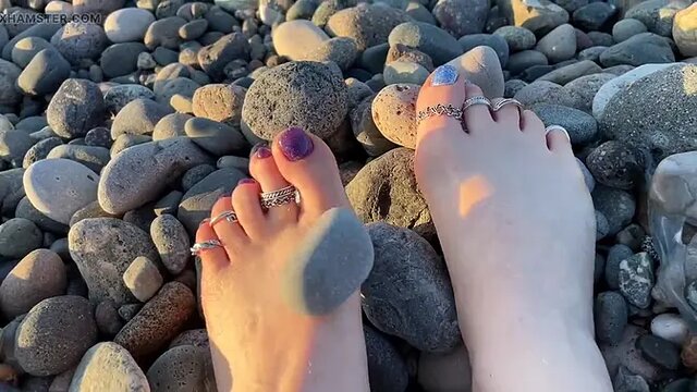 Mistress Lara's sexy feet get a sensual massage on the public beach