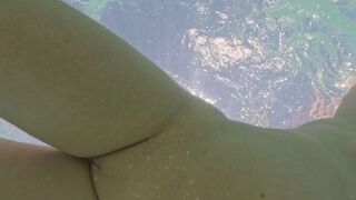 Curvy naked girl swims underwater with anal plug