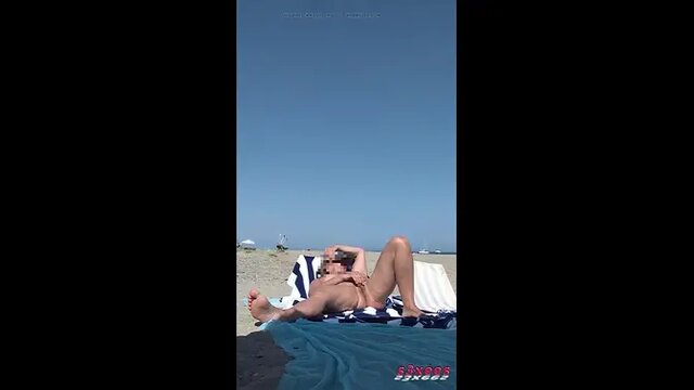 Solo female masturbation on naturist beach catches voyeur's eye