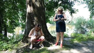 Two girls stopped on the side of the road to pee, attracting the attention of passing cars, golden shower in a public place
