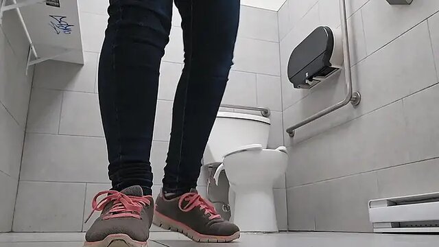 Desperate nerdy girl with glasses pees in toilet and on outdoor plants