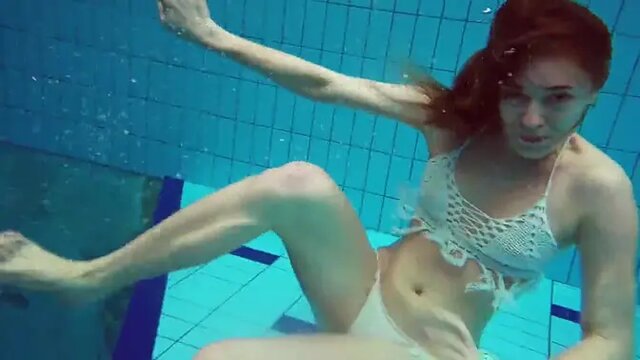 Tight 18 year old blonde babe shows her pussy underwater in a public pool